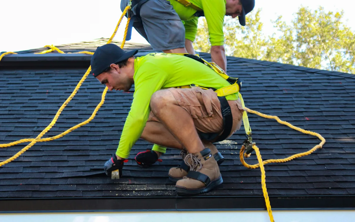 Roofing professionals assessing a property