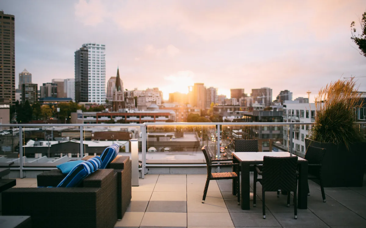 Furnished rooftop terrace overlooking a city skyline
